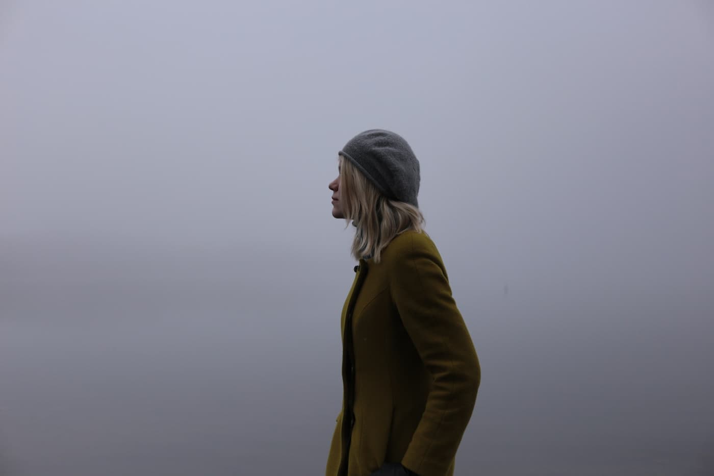 Olive outerwear photographed outdoors in soft light